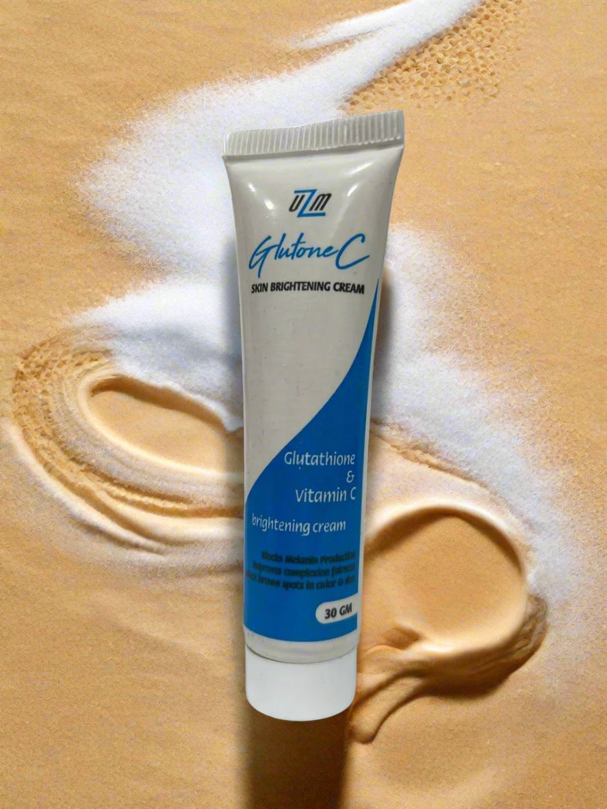 Tube of Glutone C skin brightening cream on a white surface with a blurred background