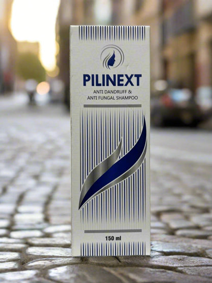 Pilinext shampoo box on a white surface with blurred background