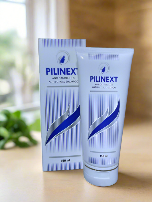 This image features a package and tube of Pilinext Shampoo, designed for hair care. The package, including a box and a tube, displays a clean, professional look with a predominantly white color accented by blue stripes.