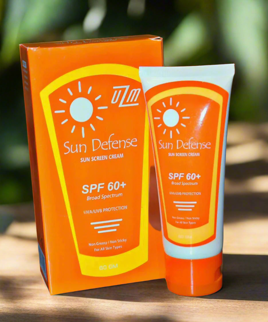 A tube of Sundefense sunscreen cream with SPF 60+ is displayed next to its packaging, which is also orange with sun protection messages.
