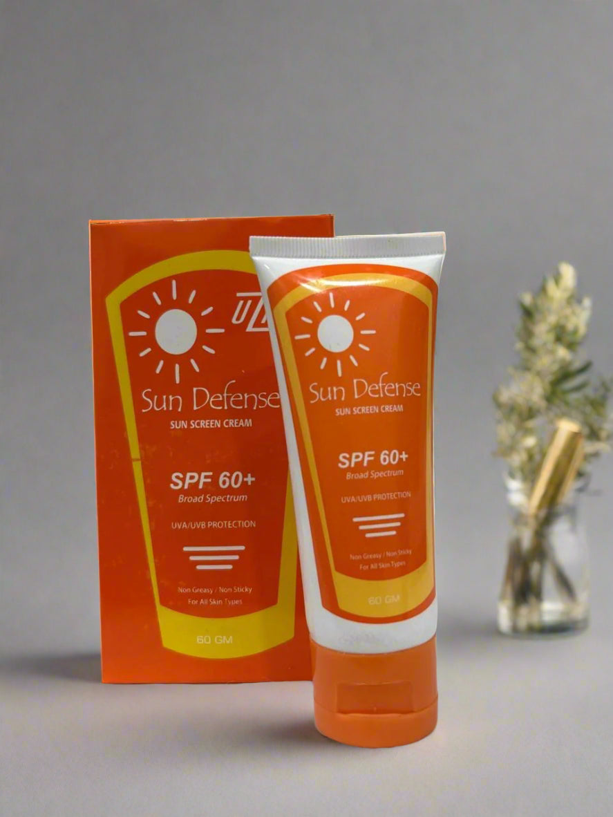 Sun Defense sunscreen cream and packaging on a white surface